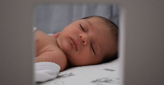 A serene image of a sleeping baby lying peacefully indoors. Captured in soft and gentle lighting.